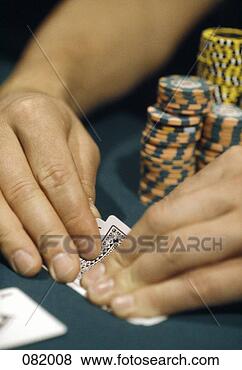 Stock Photo - a man looking 
at his cards in 
a casino, las 
vegas, nevada, 
usa. fotosearch 
- search stock 
photos, pictures, 
images, and photo 
clipart
