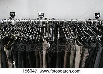 Picture - high angle view 
of a large number 
of trousers hanging 
in a clothing. 
fotosearch - search 
stock photos, 
pictures, images, 
and photo clipart