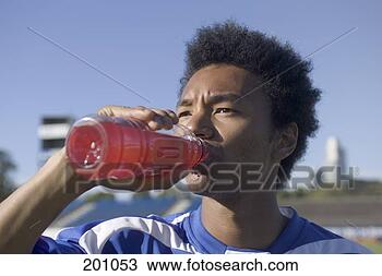 Stock Photo - a soccer player 
drinking a sports 
drink. fotosearch 
- search stock 
photos, pictures, 
images, and photo 
clipart