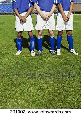 Stock Photo - three soccer players 
protecting themselves 
from a free kick. 
fotosearch - search 
stock photos, 
pictures, images, 
and photo clipart