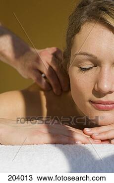 Stock Photo - young woman with 
eyes closed receiving 
massage. fotosearch 
- search stock 
photos, pictures, 
images, and photo 
clipart