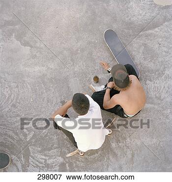 Picture - two teenagers 
sat in skate park, 
aerial view. fotosearch 
- search stock 
photos, pictures, 
images, and photo 
clipart