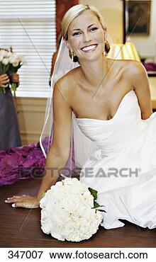 Picture - bride leaning 
on wooden table 
next to wedding 
bouquet. fotosearch 
- search stock 
photos, pictures, 
images, and photo 
clipart