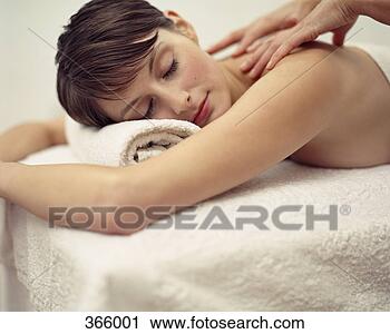 Stock Photography - woman receiving 
a massage at a 
beauty spa. fotosearch 
- search stock 
photos, pictures, 
images, and photo 
clipart