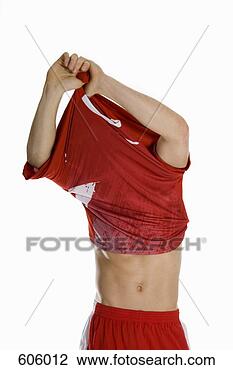 Banco de Imagem - macho,  atleta, 
 levando,  desligado, 
 seu,  camisa. 
fotosearch - busca 
de fotos, imagens 
e clipart
