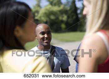 Stock Photography - university students 
socializing on 
campus. fotosearch 
- search stock 
photos, pictures, 
images, and photo 
clipart