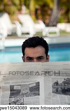 Stock Photograph - portrait of a 
young man peeping 
over a newspaper. 
fotosearch - search 
stock photos, 
pictures, images, 
and photo clipart