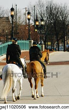Stock Photo - rear view of two 
people riding 
horses, baltimore, 
maryland, usa. 
fotosearch - search 
stock photos, 
pictures, images, 
and photo clipart