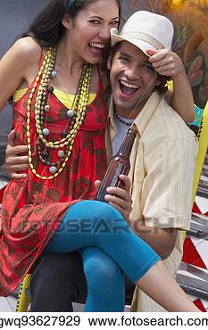 Stock Photograph - portrait of a 
young woman sitting 
on the lap of 
a young man. fotosearch 
- search stock 
photos, pictures, 
images, and photo 
clipart