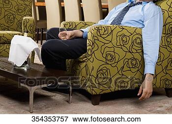 Picture - drunk businessman 
sitting in an 
armchair. fotosearch 
- search stock 
photos, pictures, 
wall murals, images, 
and photo clipart