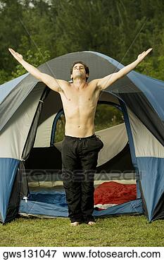 Picture - mid adult man 
standing in front 
of a dome tent 
with his arms. 
fotosearch - search 
stock photos, 
pictures, images, 
and photo clipart