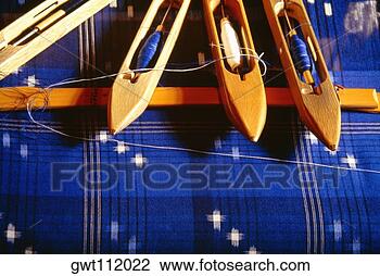 Stock Photo - weaver's bobbins 
on indigo fabric, 
matsuyama, japan. 
fotosearch - search 
stock photos, 
pictures, images, 
and photo clipart