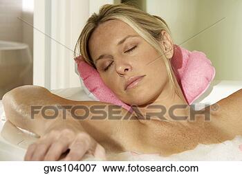 Picture - close-up of a 
young woman in 
a bathtub with 
her eyes closed. 
fotosearch - search 
stock photos, 
pictures, images, 
and photo clipart