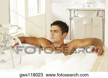 Stock Photo - high angle view 
of a bare chested 
young man in a 
bubble bath. fotosearch 
- search stock 
photos, pictures, 
images, and photo 
clipart