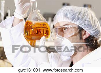 Stock Photography - side profile of 
a mid adult man 
holding liquid 
in a conical flask. 
fotosearch - search 
stock photos, 
pictures, images, 
and photo clipart