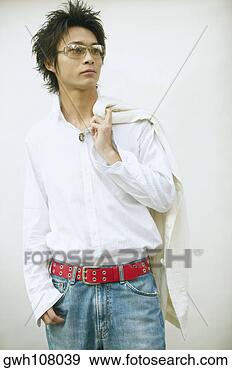 Stock Photograph - close-up of a 
young man standing 
with his hand 
in his pocket 
and a. fotosearch 
- search stock 
photos, pictures, 
images, and photo 
clipart
