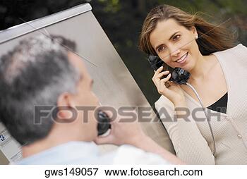 Picture - close-up of a 
mid adult couple 
talking on a pay 
phone. fotosearch 
- search stock 
photos, pictures, 
images, and photo 
clipart