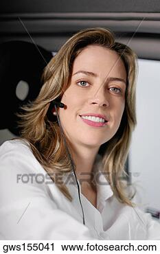 Stock Photography - portrait of a 
young woman wearing 
a hands free device 
and listening. 
fotosearch - search 
stock photos, 
pictures, images, 
and photo clipart