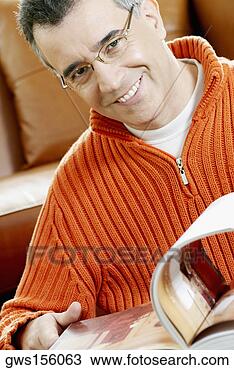 Stock Photo - close-up of a 
mid adult man 
turning the pages 
of a magazine. 
fotosearch - search 
stock photos, 
pictures, images, 
and photo clipart