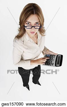 Stock Photography - high angle view 
of a businesswoman 
using a calculator. 
fotosearch - search 
stock photos, 
pictures, images, 
and photo clipart