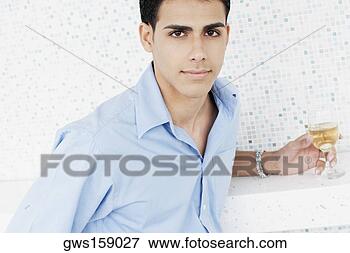 Picture - portrait of a 
young man holding 
a glass of wine. 
fotosearch - search 
stock photos, 
pictures, images, 
and photo clipart