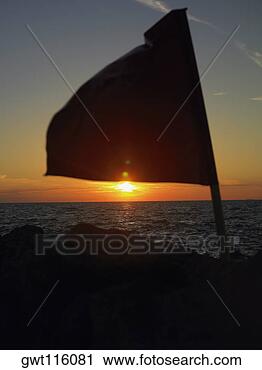 Stock Photography - close-up of a 
flag fluttering 
on a rock, cartagena, 
colombia. fotosearch 
- search stock 
photos, pictures, 
images, and photo 
clipart
