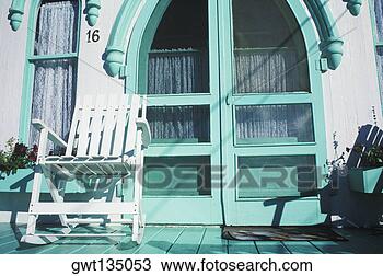 Stock Photo - rocking chair 
in front of a 
closed door. fotosearch 
- search stock 
photos, pictures, 
images, and photo 
clipart