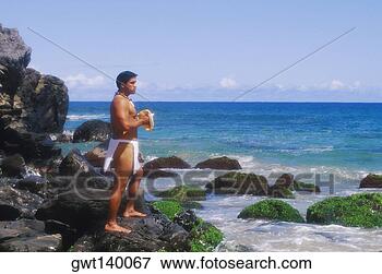 Picture - side profile of 
a young man standing 
on a rock and 
holding a conch. 
fotosearch - search 
stock photos, 
pictures, images, 
and photo clipart