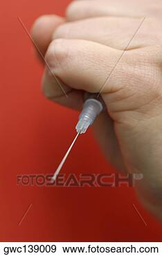 Stock Photograph - close-up of a 
person's hand 
holding a syringe. 
fotosearch - search 
stock photos, 
pictures, images, 
and photo clipart