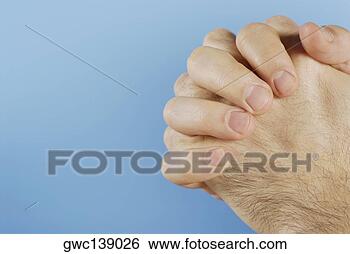 Stock Photo - close-up of person's 
hands clasped. 
fotosearch - search 
stock photos, 
pictures, images, 
and photo clipart