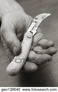 Stock Photography - close-up of a 
person's hand 
holding a knife. 
fotosearch - search 
stock photos, 
pictures, images, 
and photo clipart