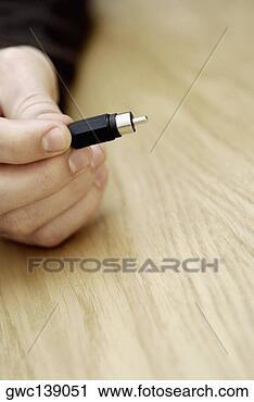 Stock Photography - close-up of a 
person's hand 
holding an electrical 
plug. fotosearch 
- search stock 
photos, pictures, 
images, and photo 
clipart