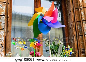 Stock Photography - close-up of a 
pinwheel in front 
of a window. fotosearch 
- search stock 
photos, pictures, 
images, and photo 
clipart