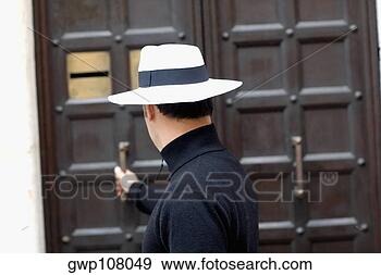 Stock Photograph - side profile of 
a man opening 
the door. fotosearch 
- search stock 
photos, pictures, 
images, and photo 
clipart