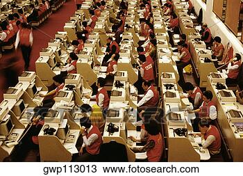 Stock Photo - high angle view 
of businessmen 
and businesswomen 
working at a stock. 
fotosearch - search 
stock photos, 
pictures, images, 
and photo clipart