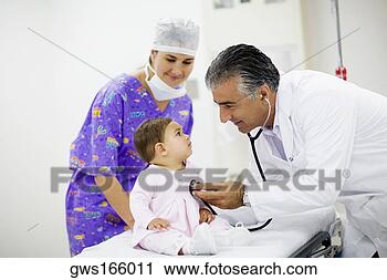 Stock Photography - side profile of 
a male doctor 
examining a baby 
girl with a. fotosearch 
- search stock 
photos, pictures, 
images, and photo 
clipart