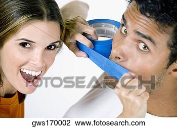 Stock Photo - portrait of a 
mid adult woman 
sticking an adhesive 
tape on a young. 
fotosearch - search 
stock photos, 
pictures, images, 
and photo clipart