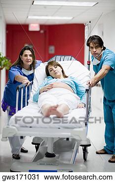 Stock Photography - male and a female 
doctor pushing 
a pregnant young 
woman lying on 
a. fotosearch 
- search stock 
photos, pictures, 
images, and photo 
clipart