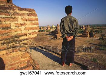 Stock Photography - rear view of a 
man looking at 
pagodas, bagan, 
myanmar. fotosearch 
- search stock 
photos, pictures, 
images, and photo 
clipart