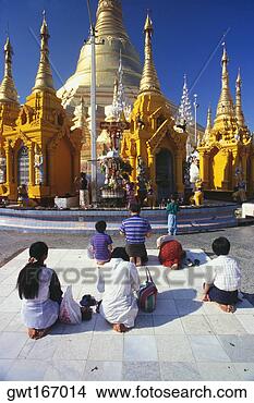 Stock Photo - rear view of pilgrims 
praying in front 
of a pagoda,  
shwedagon. fotosearch 
- search stock 
photos, pictures, 
images, and photo 
clipart