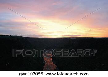 Stock Photo - high angle view 
of a river passing 
through mountains 
at sunset. fotosearch 
- search stock 
photos, pictures, 
images, and photo 
clipart
