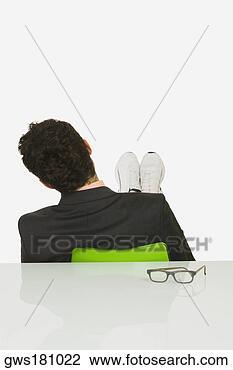 Stock Photo - rear view of a 
businessman sitting 
with his feet 
up in an office. 
fotosearch - search 
stock photos, 
pictures, images, 
and photo clipart