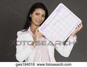Stock Photo - close-up of a 
businesswoman 
holding a calendar. 
fotosearch - search 
stock photos, 
pictures, images, 
and photo clipart