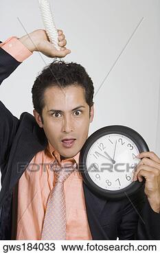 Stock Photo - portrait of a 
businessman holding 
a noose and a 
clock. fotosearch 
- search stock 
photos, pictures, 
images, and photo 
clipart