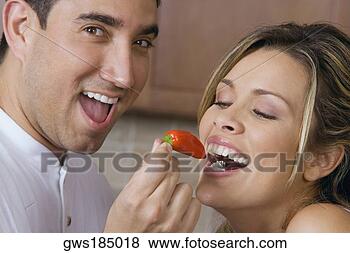 Stock Photo - close-up of a 
mid adult man 
feeding a red 
chili pepper to 
a young. fotosearch 
- search stock 
photos, pictures, 
images, and photo 
clipart