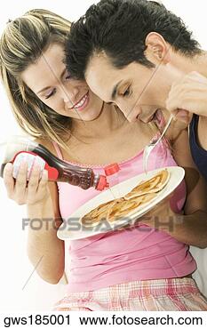 Stock Photography - close-up of a 
young couple having 
breakfast. fotosearch 
- search stock 
photos, pictures, 
images, and photo 
clipart