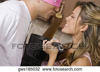 Stock Photo - close-up of a 
young woman making 
a blindfolded 
mid adult man 
to taste. fotosearch 
- search stock 
photos, pictures, 
images, and photo 
clipart