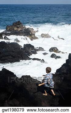 Stock Photograph - rear view of a 
boy standing on 
a cliff,  kehena 
beach,  big island. 
fotosearch - search 
stock photos, 
pictures, images, 
and photo clipart