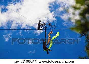 Stock Photo - silhouette of 
two performers 
performing stunt 
on a rope,  emerald. 
fotosearch - search 
stock photos, 
pictures, images, 
and photo clipart