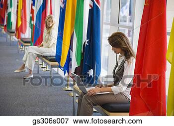 Picture - women with laptop 
and international 
flags. fotosearch 
- search stock 
photos, pictures, 
images, and photo 
clipart